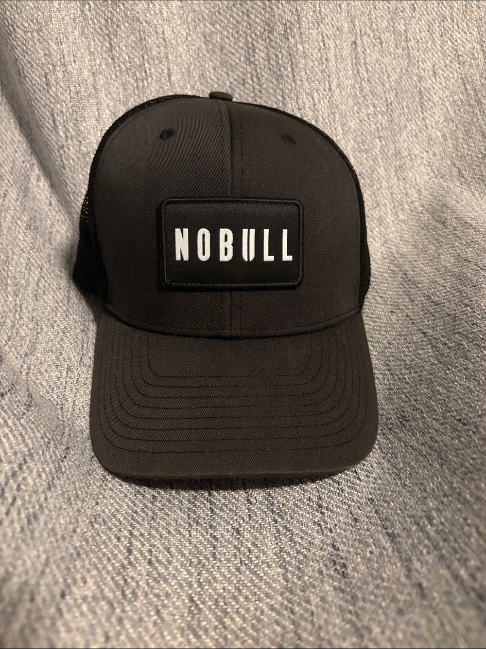 NOBULL Black Patch Trucker Hat with White Logo